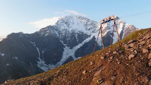 Drag Lift on Top of Mountain Against Snowy Peaks of Elbrus