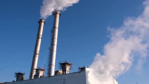 Industrial Smokestacks Against a Clear Blue Sky