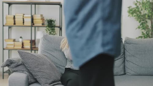 Distraught Woman Sitting on Couch with Relationship Conflict