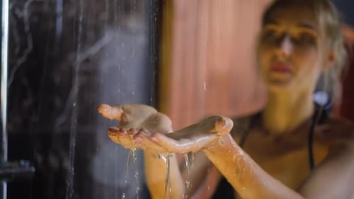 Woman's Hands Under Shower Water