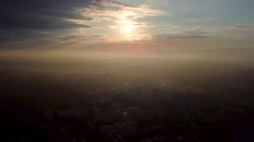 Sunrise in city with epic clouds, fog, sun shine