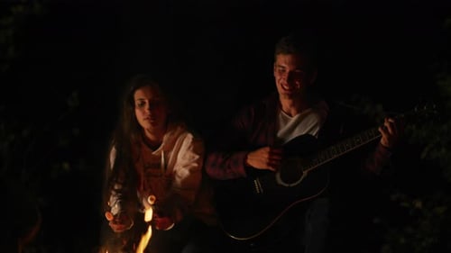 Friends Sing, Play Guitar by Campfire at Night