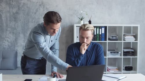 Two business persons are work together in modern office. Team of businessmen.