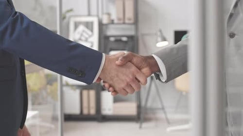 Businessmen Shaking Hands in Modern Office Environment