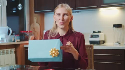 Woman Talks About Gift in Kitchen