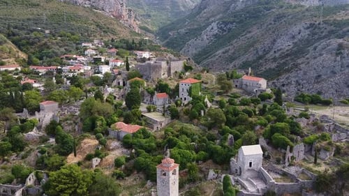 Scenic Village and Ruins in Mountainous Landscape