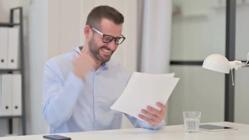 Man Celebrates Good News in Office