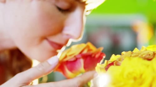 Woman Smelling Colorful Flowers Up Close