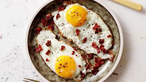 Fried Eggs with Crispy Bacon on Plate
