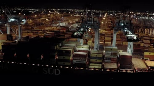 Aerial View of Cargo Ship with Cargo Containers Stands on a Berth in the Port at the Loading and