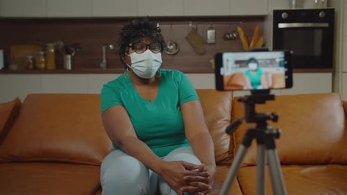 Woman With Mask Filming Video in Home