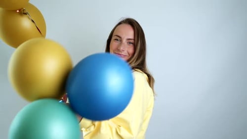 Happy Woman with Balloons in a Home Setting