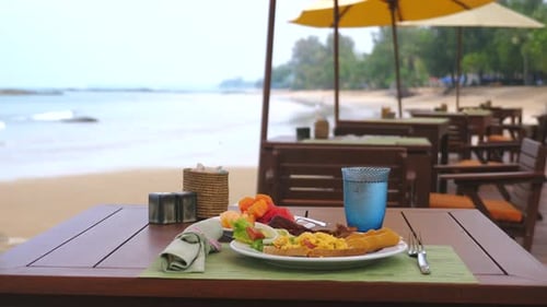 Breakfast on Tropical Beach at Restaurant Table