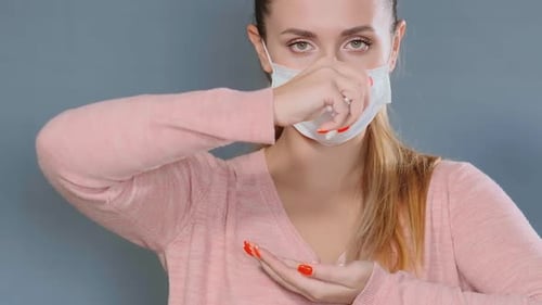 Young Woman in White Disposable Mask Throws Various Pills