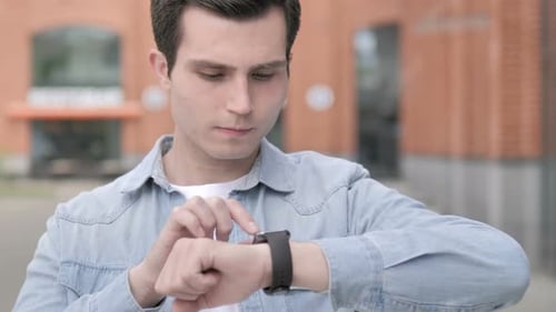Adult Using Smartwatch Technology in Urban Setting