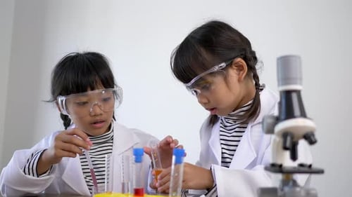 Enthusiastic Children Doing Science Experiments in Laboratory