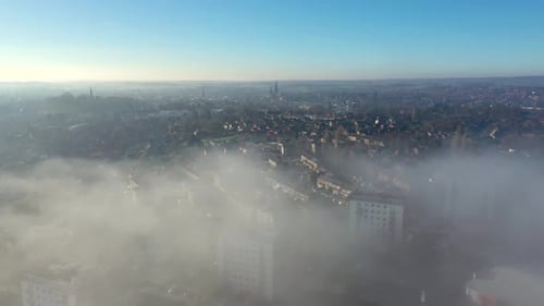 Aerial view of a city with its cathedral and a lake in the early morning