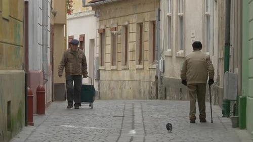 Old men walking on a narrow street