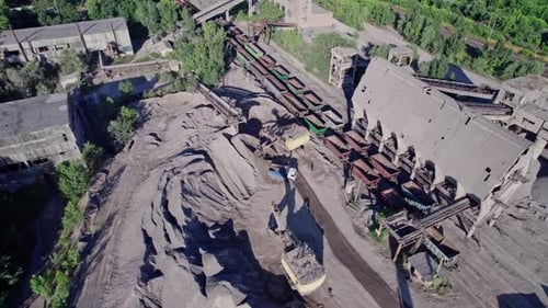 Excavator Loading Crushed Stone Into a Dump Truck in a Crushed Stone Quarry