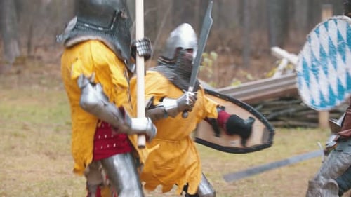 Four Men Knightes Having a Training Fight Outdoors