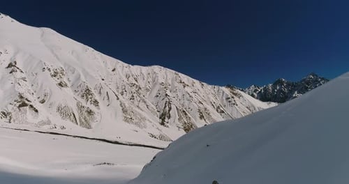 Snowboarder Carves His Board Through Snow Down Cool Mountain Landscape in Chile Andes Range