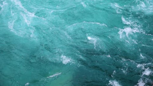 Turquoise Water Flowing in a Rushing River