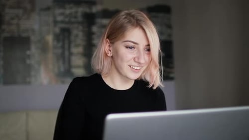 Woman Working on Laptop Computer at Home