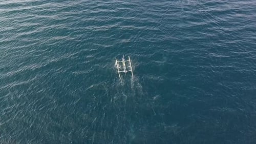 Aerial View of Asian Tourist Boat Moving Fast in the Wavy Ocean on Summer Day.