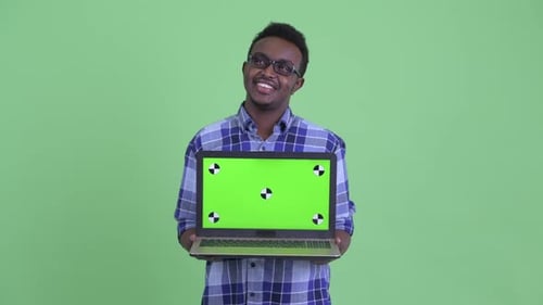 Young Adult Holding Laptop with Green Screen