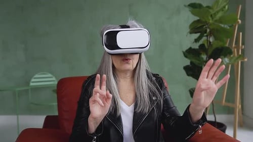 Senior Woman Experiencing Virtual Reality Headset at Home