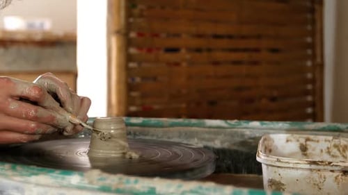 Mid section of potter making pot