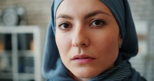 Close-up of Attractive Middle Easter Lady in Hijab Looking at Camera in Office