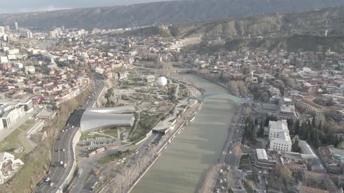 Aerial view of Tbilisi city central park and Bridge of Peace. Beautiful cityscape of old Tbilisi