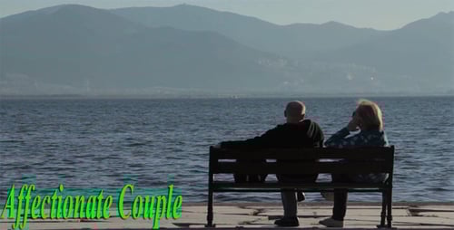 Couple Sitting on Bench Looking at Water