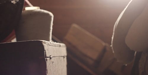 Dimly Lit Interior with Stacked Wood and Crate