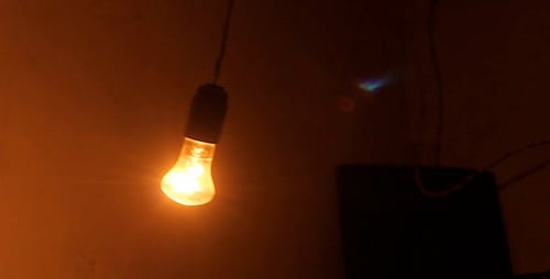Swinging Light Bulb Illuminates the Darkness