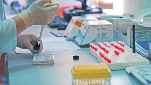 Scientist Pipetting Liquid in a Bright Laboratory