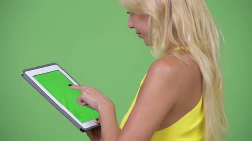 Woman Using Digital Tablet with Chroma Key Screen