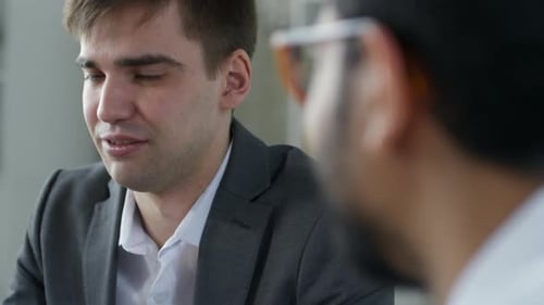 Caucasian Businessman Talking with Colleagues in Office