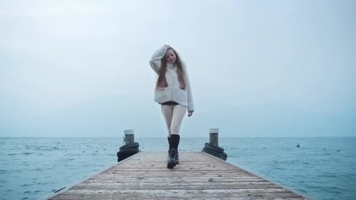 Woman with Long Hair Walks on Wooden Pier in Lake Garda