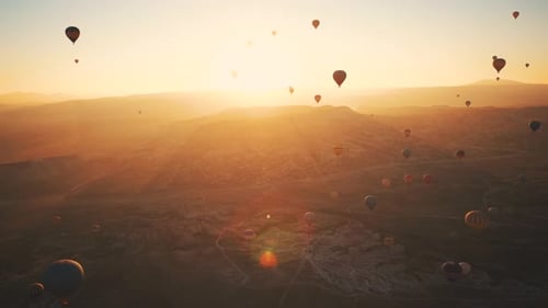 Hot Air Balloons Flying at Sunrise Aerial View