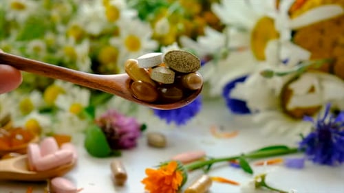 Pills Spill from Spoon onto Flowers