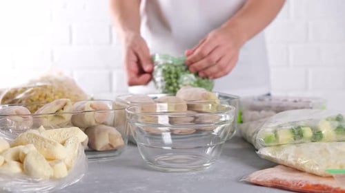 Pouring Frozen Peas Into Bowl in Bright Kitchen