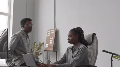 Programmers Chatting in Office