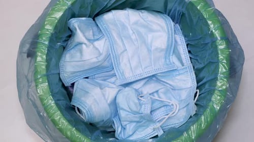 Discarded Surgical Masks Filling Trash Can Close Up