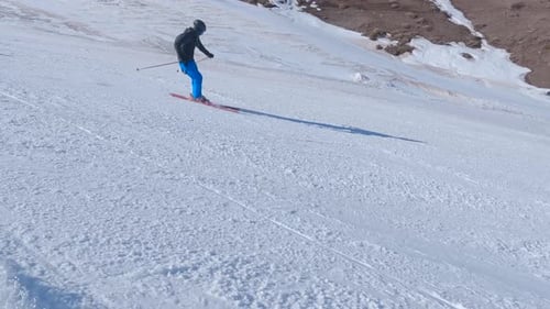 Skier Glides Down Snowy Mountain Slope