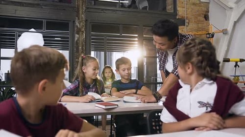 Children Reading Books in Classroom with Teacher