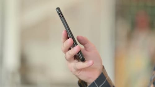 Close Up of Young Man Using Smartphone with Single Hand