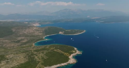 aerial view of rocky coast beach with blue water