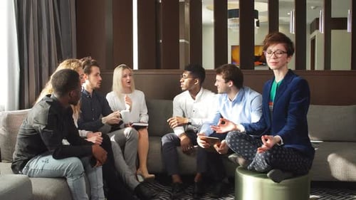 Diverse Group Conversing in Casual Workplace